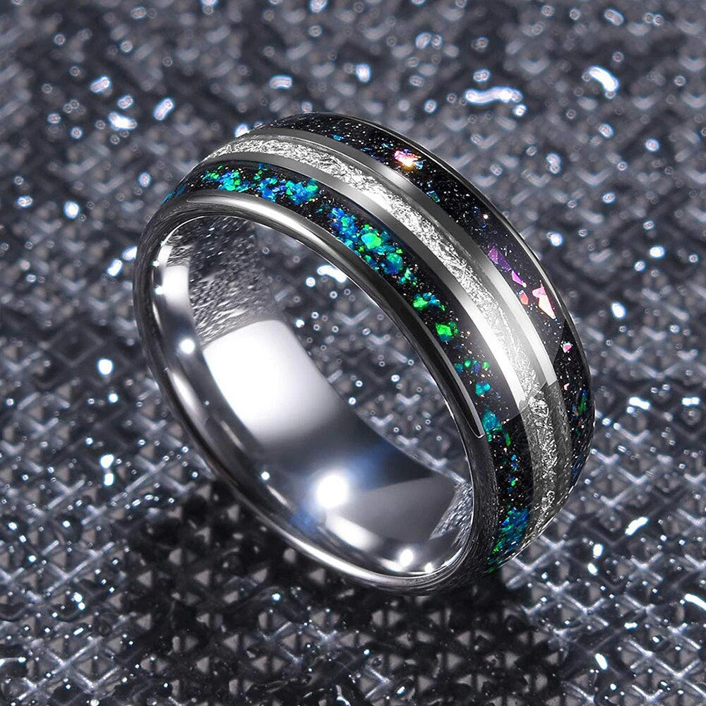 Galaxy ring with meteorite inlay and holographic opal on a black background.