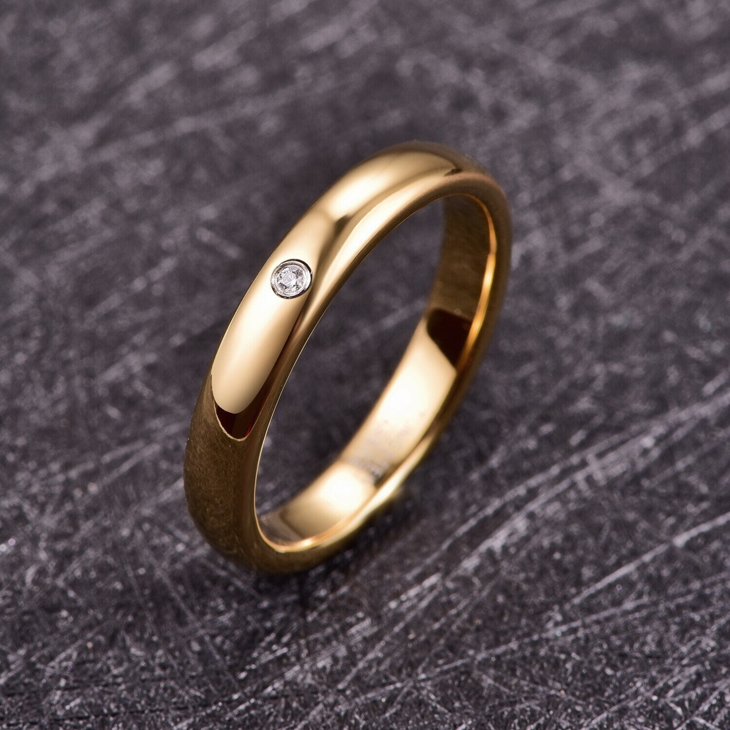 Gypsy wedding band in gold Tungsten with a flush set cubic zirconia stone.