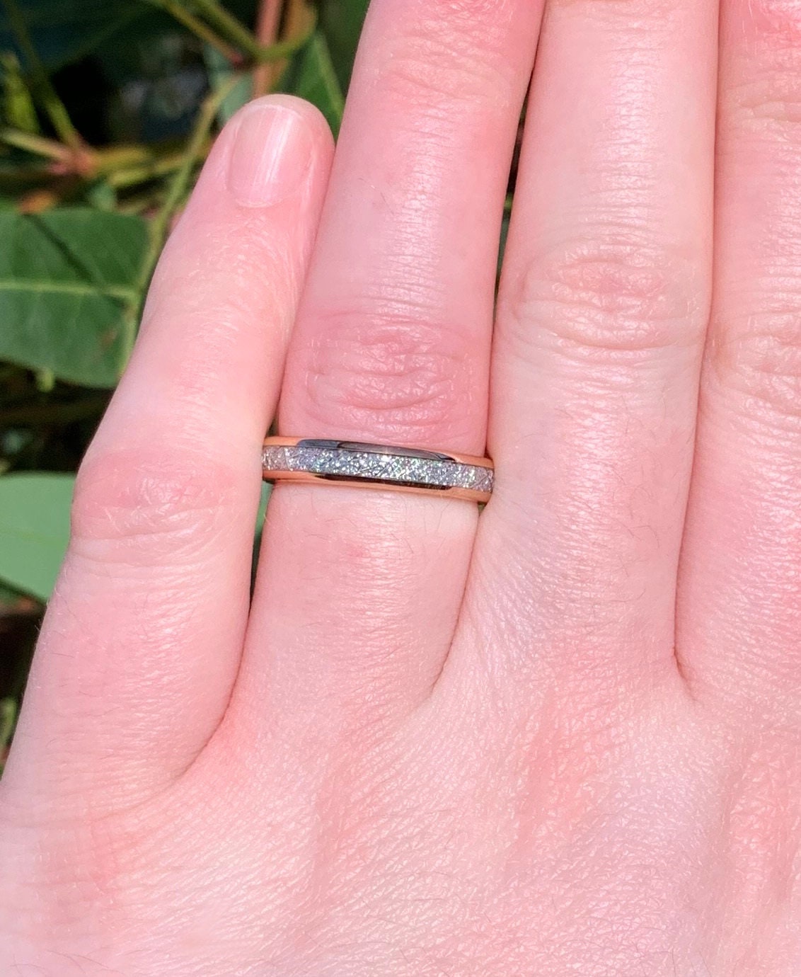 Rose gold Tungsten meteorite ring showcased on a woman's hand