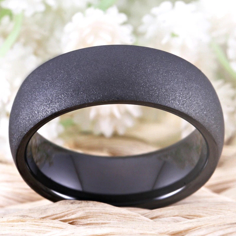 Matte black male wedding ring crafted from black Tungsten with a domed band.