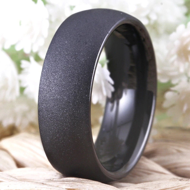 Matte black mens ring with a sandblasted finish, domed band, and polished interior.