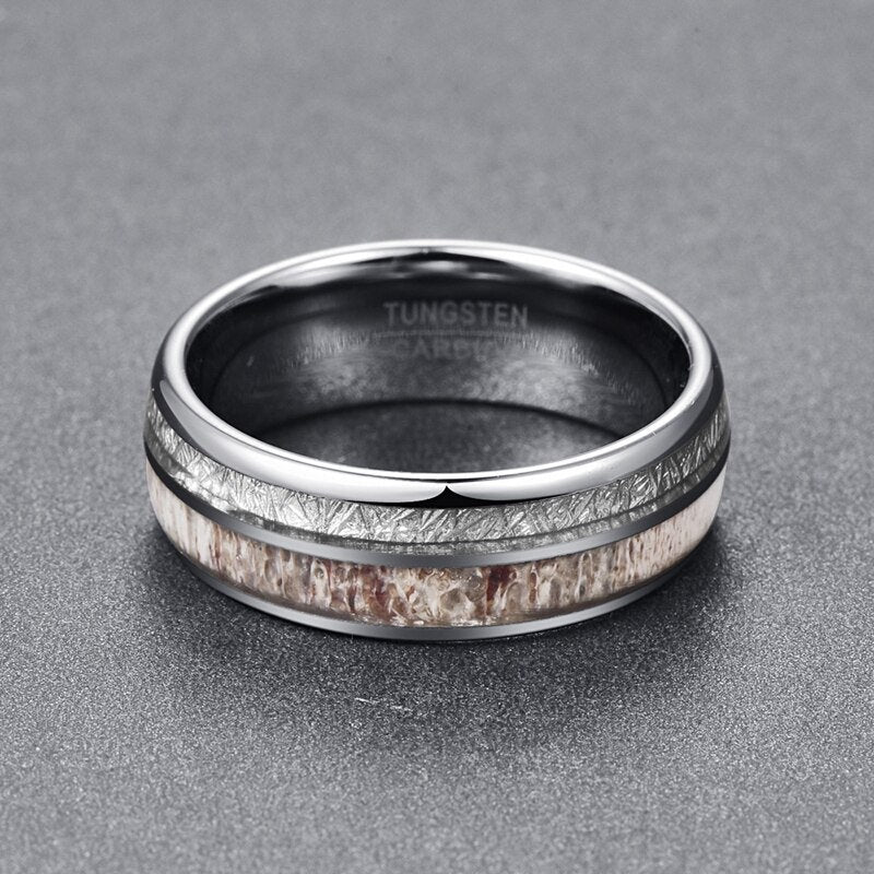 Mens meteorite wedding ring featuring a silver Tungsten band with meteorite and antler inlays.