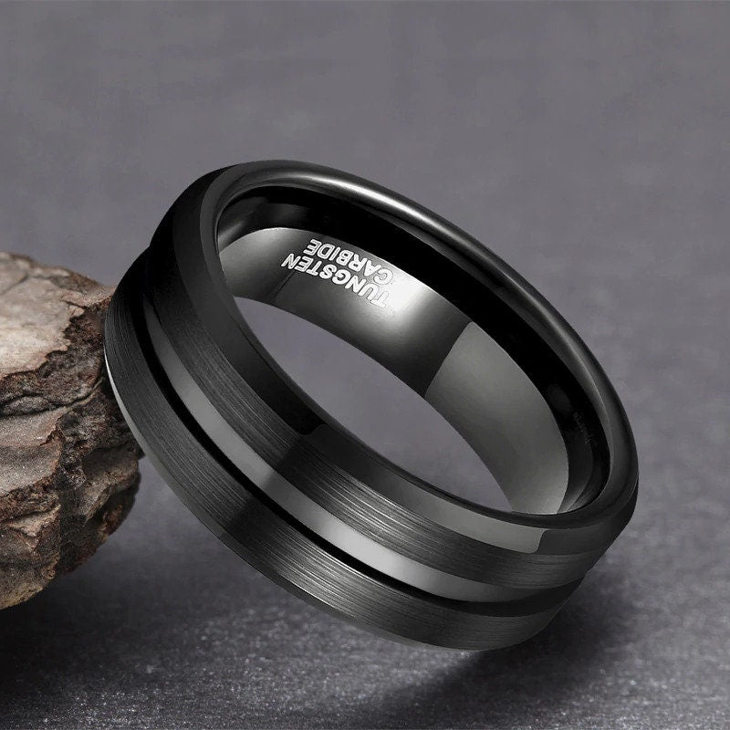 Mens wedding rings black Tungsten with brushed finish and polished stripe.