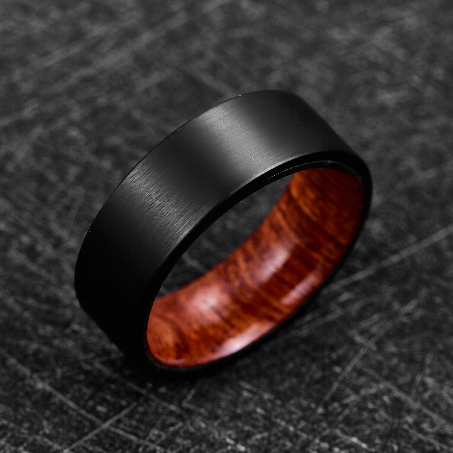 Mens wood rings with a black Tungsten exterior and polished Mahogany wood interior.