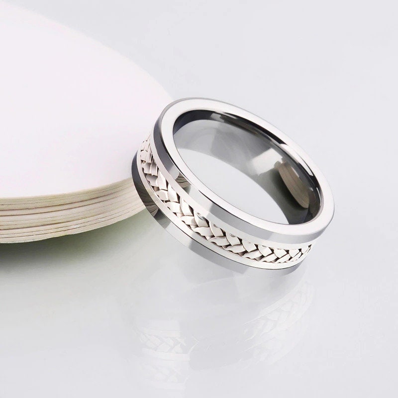 Mens woven wedding ring with comfort fit design, featuring a white gold braid.