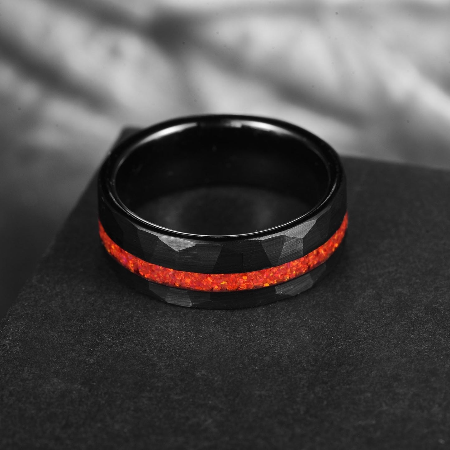 Mexican fire opal ring with a hammered black Tungsten band.