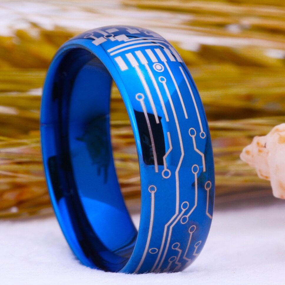 Nerd rings in 8mm blue Tungsten with laser-engraved circuitry pattern.