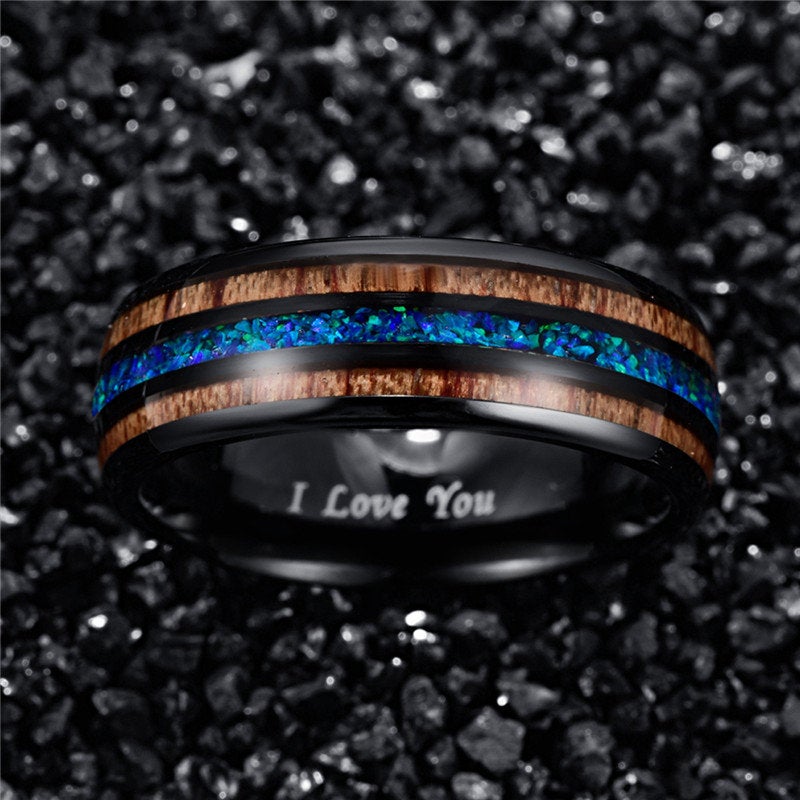 Opal mens ring with a black Tungsten band, blue-green opal, and wood inlay.