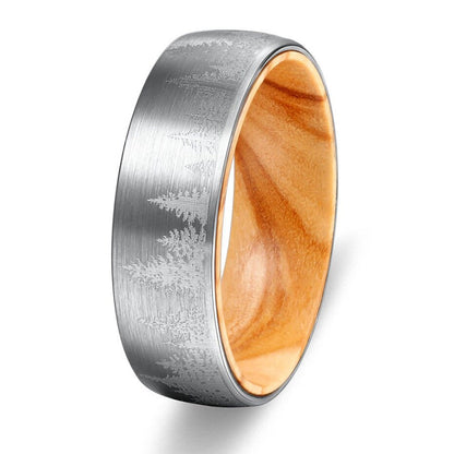 Silver ring with a domed Tungsten band, etched forest design, and natural pine wood interior.