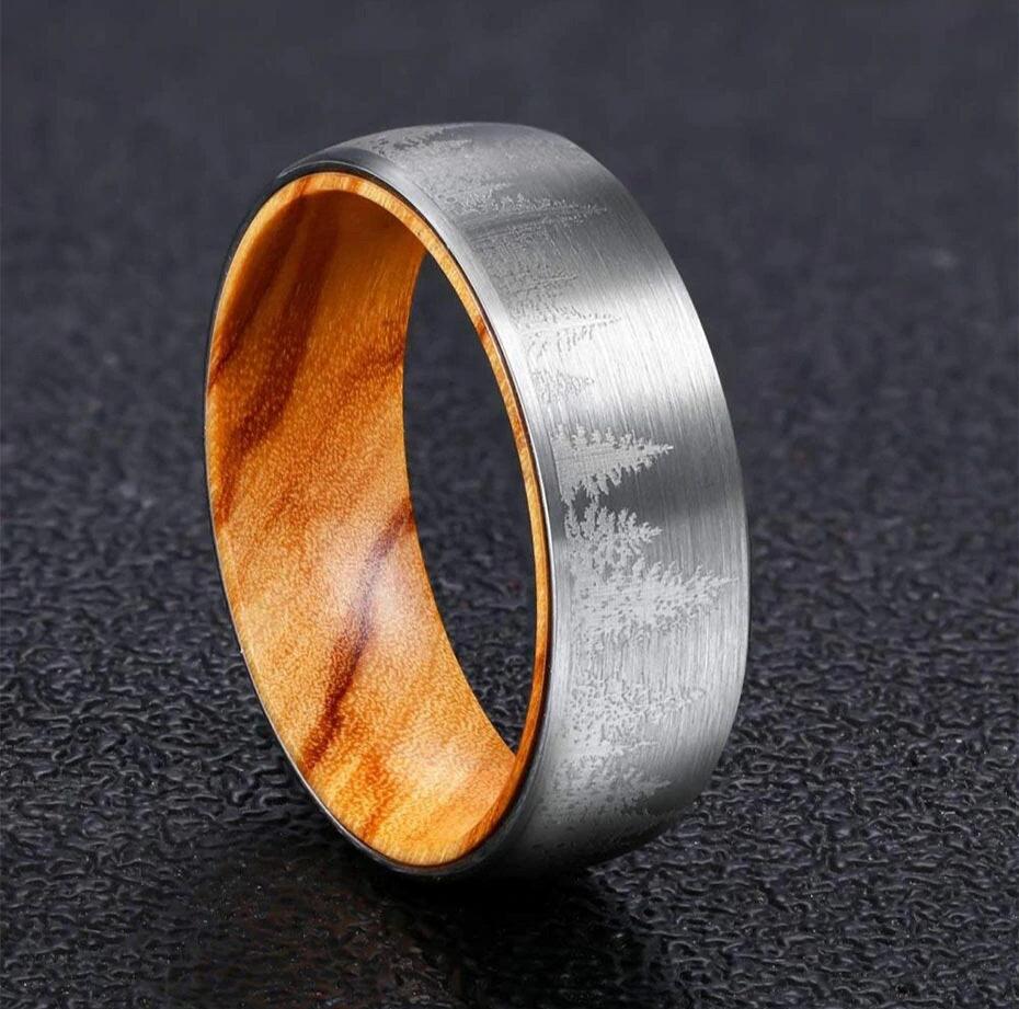 Pine tree ring with silver Tungsten exterior, forest design, and wood interior.