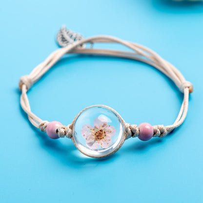 Close-up of a preserved botanical centerpiece set into an adjustable bracelet.