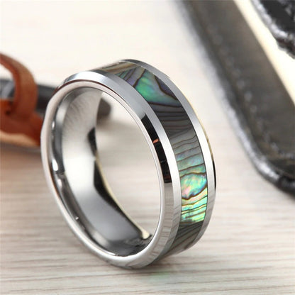 Rainbow abalone ring with a polished silver Tungsten band with beveled edges.