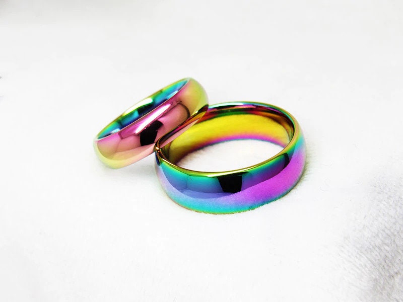 Pair of rainbow wedding rings crafted from Tungsten.