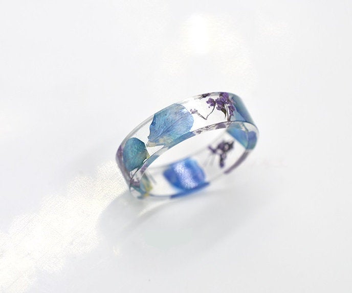 Real flower resin ring, with wildflowers suspended throughout the band.