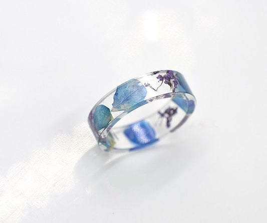 Real flower resin ring, with wildflowers suspended throughout the band.
