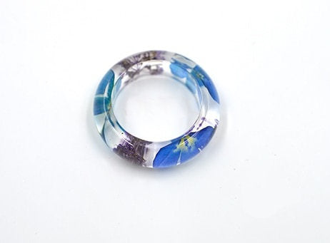 Transparent resin ring with real preserved wildflowers.