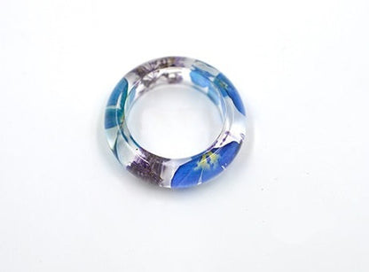 Transparent resin ring with real preserved wildflowers.