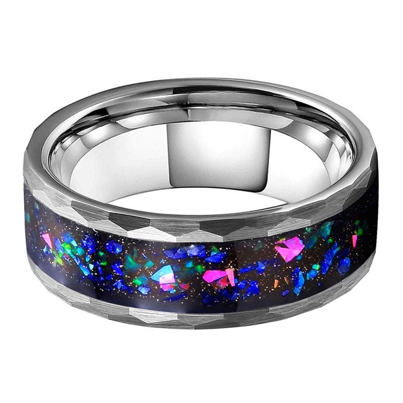 Ring galaxy design with holographic opal flakes and moondust, set in hammered tungsten.