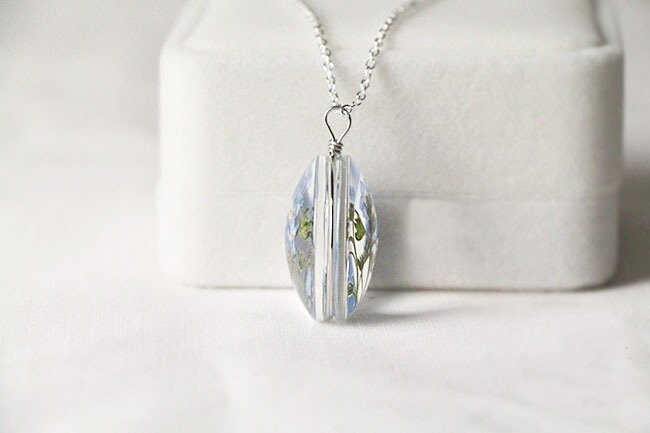 Side view of the pendant showing the clear glass and silver wire.