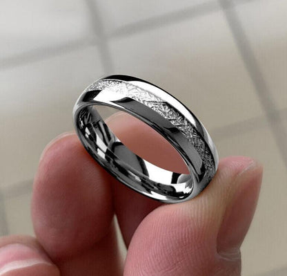 Holding a silver meteorite ring with Gibeon inlay, domed Tungsten band, comfort fit.