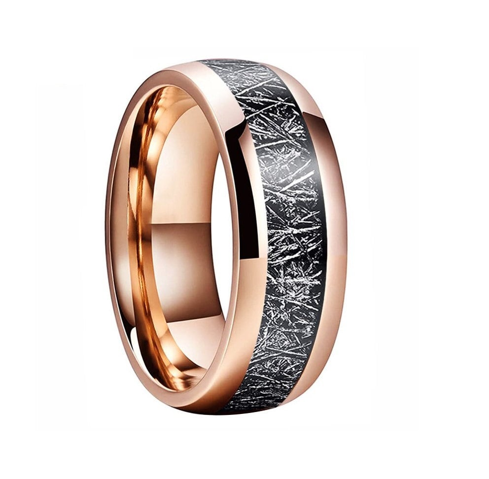 Tungsten and meteorite ring with domed band and rose gold accents.