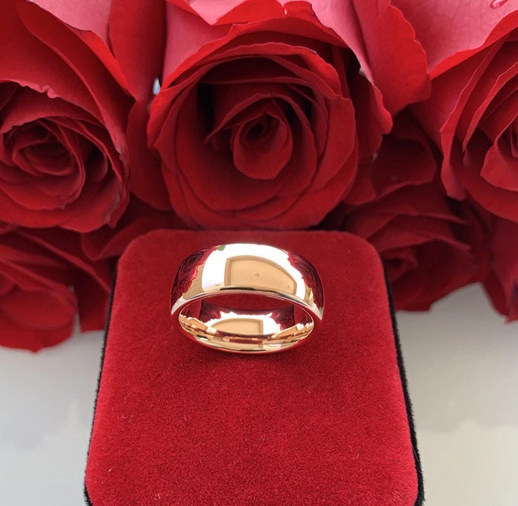 Tungsten and rose gold ring featuring a domed band and comfort fit interior.