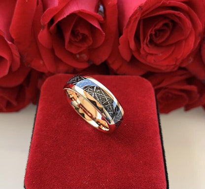 Tungsten meteorite rings on a red velvet display surrounded by roses.