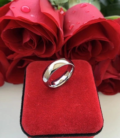 Tungsten rings silver displayed on red background with roses.