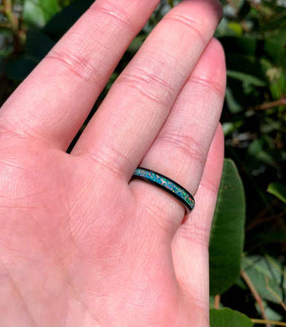 Women black opal ring in polished black Tungsten with a feminine, narrow design.