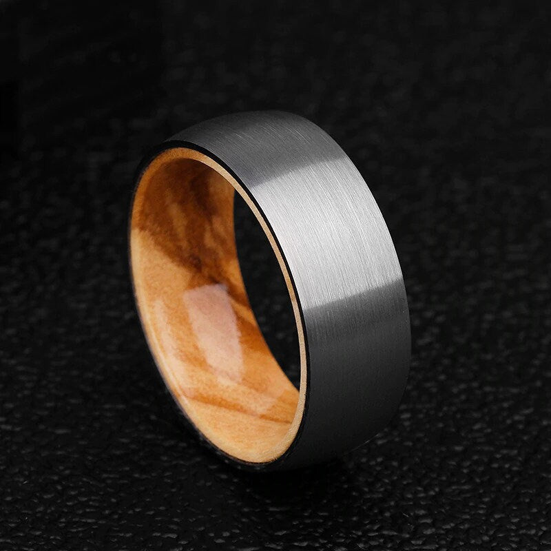 Wood rings with an Olive wood interior and brushed silver Tungsten exterior.