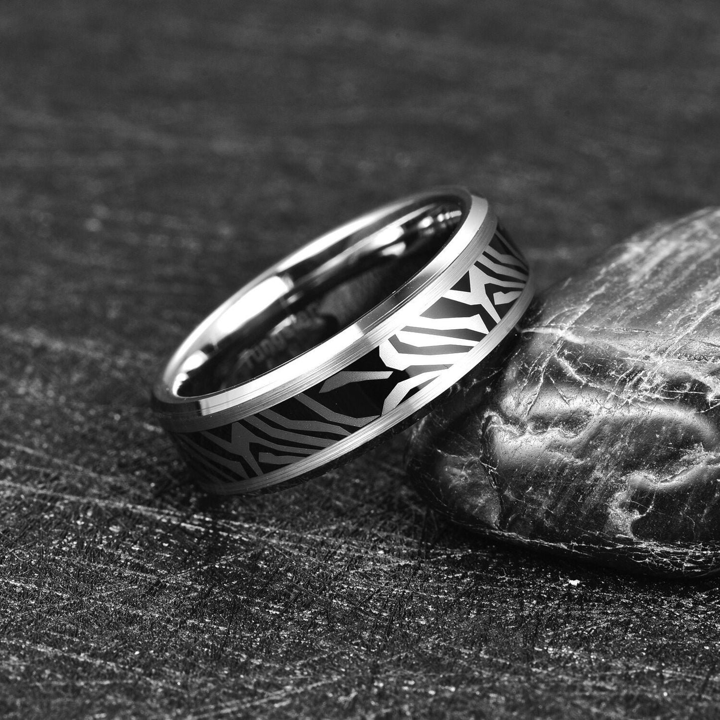 Zebra print ring with beveled edges and a black and silver Tungsten band for men.